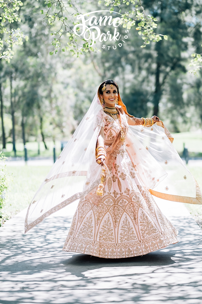 A beautiful Indian bride is in her light pink Indian Saree