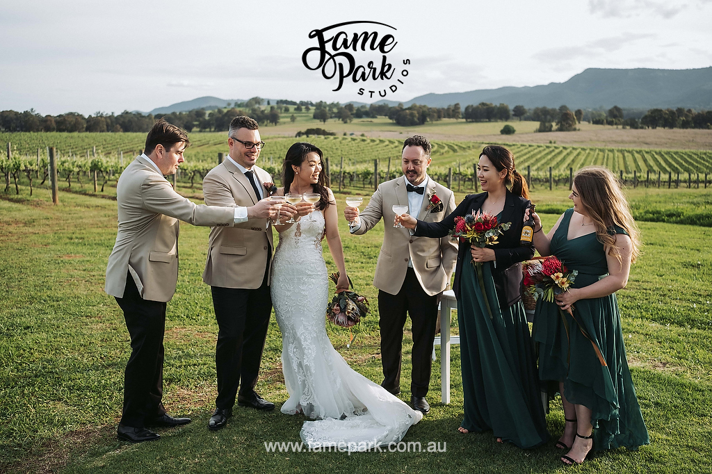 The bridal party celebrates the wedding by drinking tasty hunter valley wine