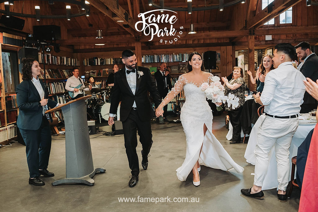 The bride and groom have their wedding reception in a rustic book barn