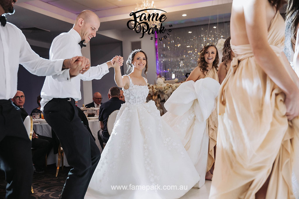 The bridal party having their traditional greek dance after they entering the reception