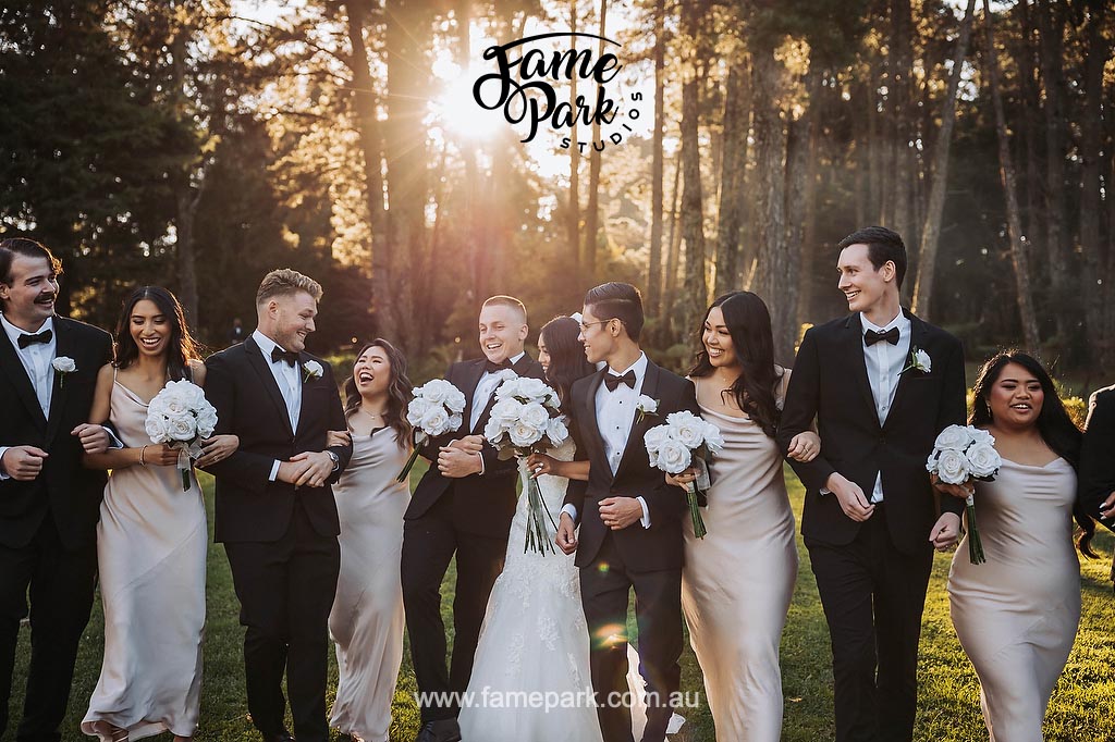 The bridal party walks towards the camera in perfect synchronization, their smiles radiating joy and excitement, creating a captivating and unified presence.