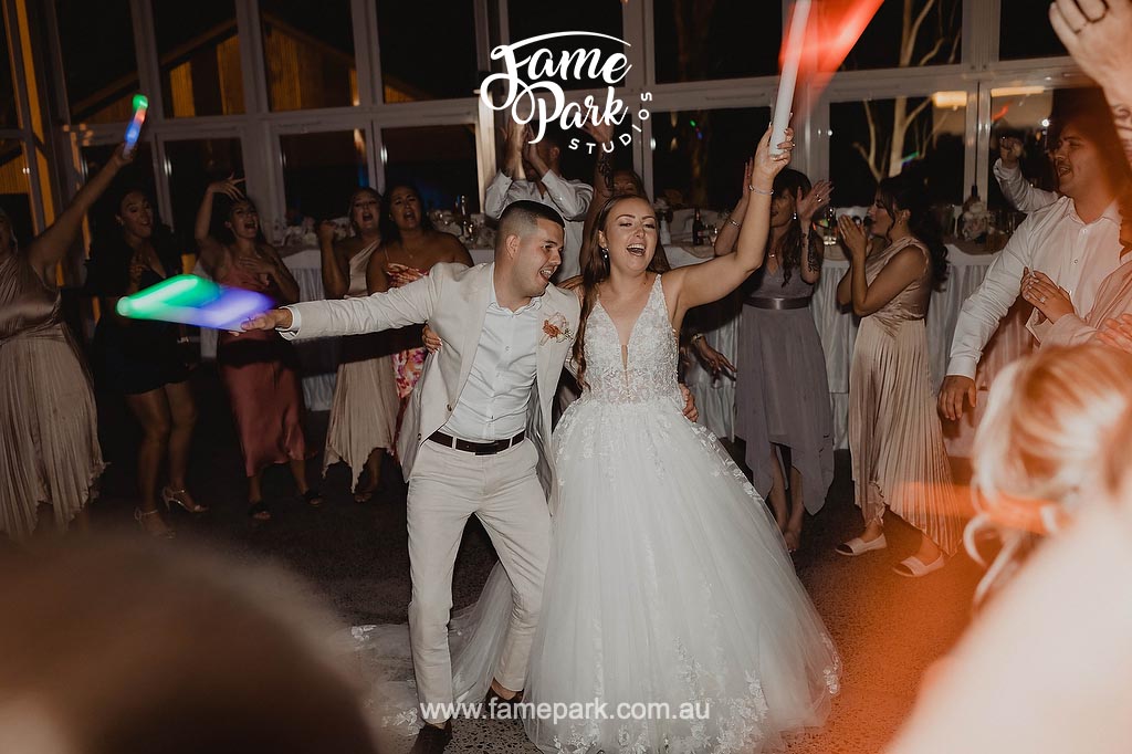 A lively wedding celebration captured in a moment of pure joy as guests dance the night away, their smiles and energetic movements filling the dance floor with infectious happiness.