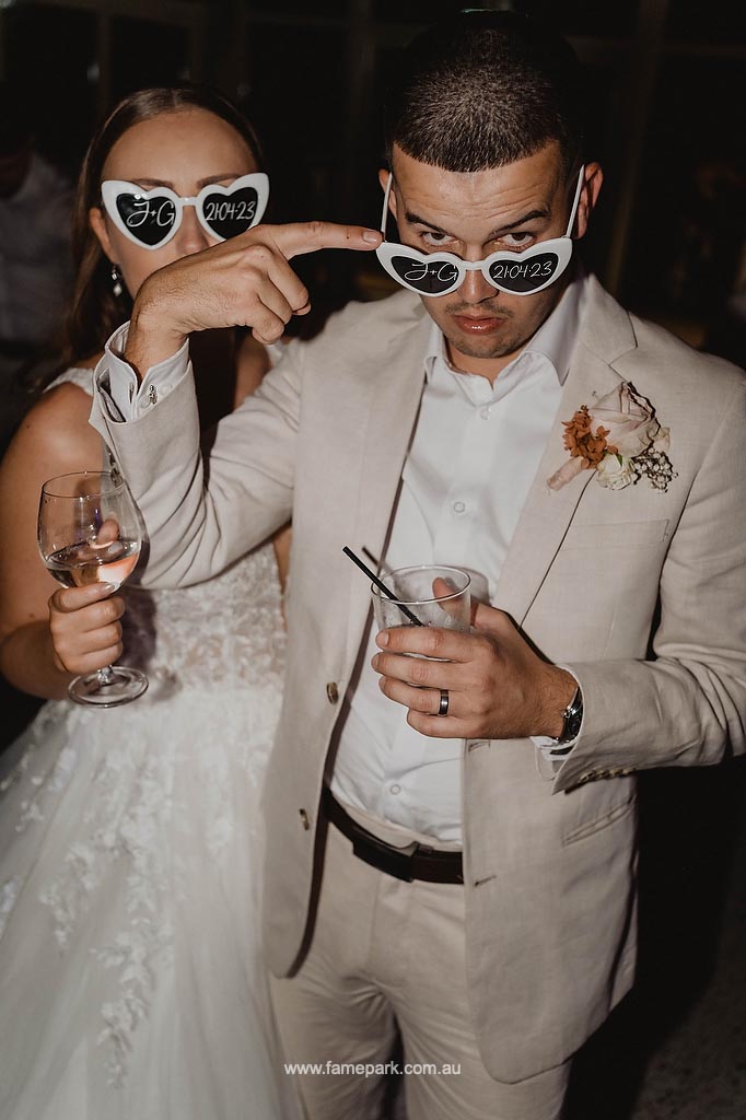 With a delightful sense of humor, the bride and groom share a comical moment as they goof around for the camera, showcasing their joyful and playful connection on their special day.
