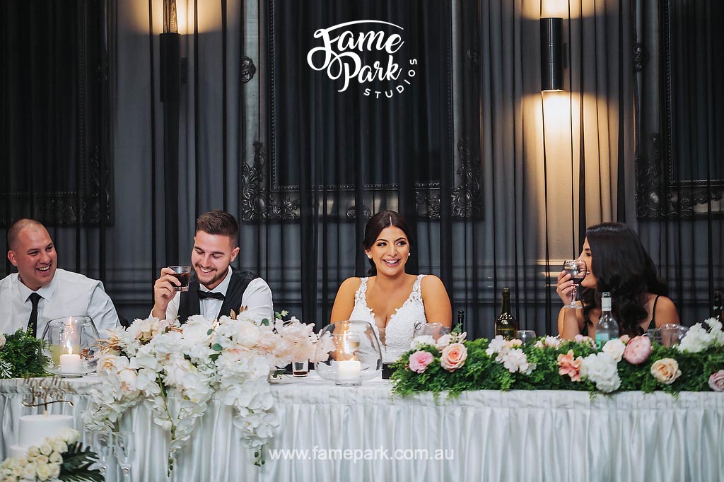 The bride and groom gather with their guests for a joyful group photo, capturing the excitement and camaraderie shared among loved ones on this special day.