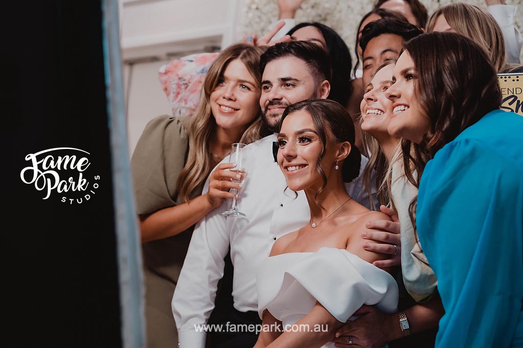 The bride and her friends strike playful poses in the photobooth, their infectious laughter and genuine camaraderie shining through in these lighthearted and unforgettable moments.