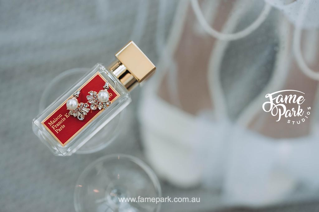 A bride-to-be gift featuring a bottle of perfume alongside a pair of wedding shoes.