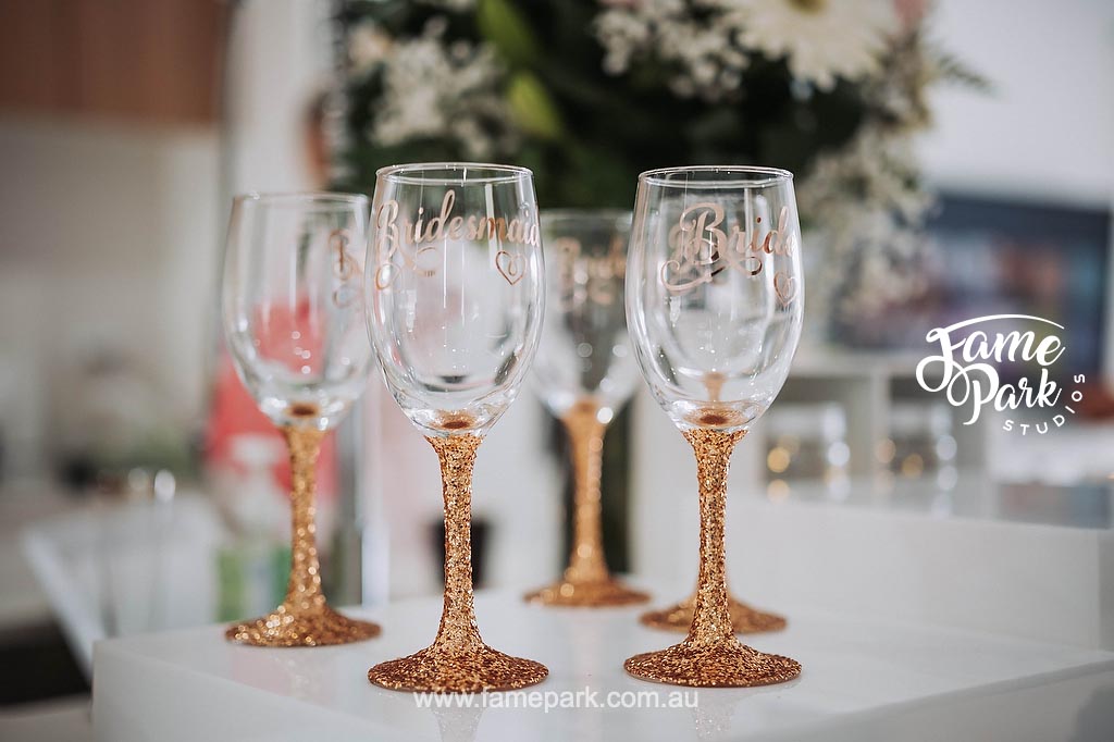 Wedding gift ideas featuring four champagne flutes lined up on a table.