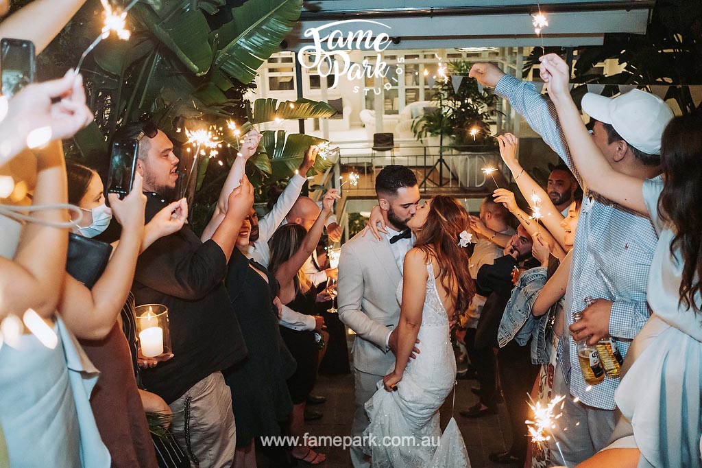 A beachside wedding celebration on the Northern Beaches with sparklers.