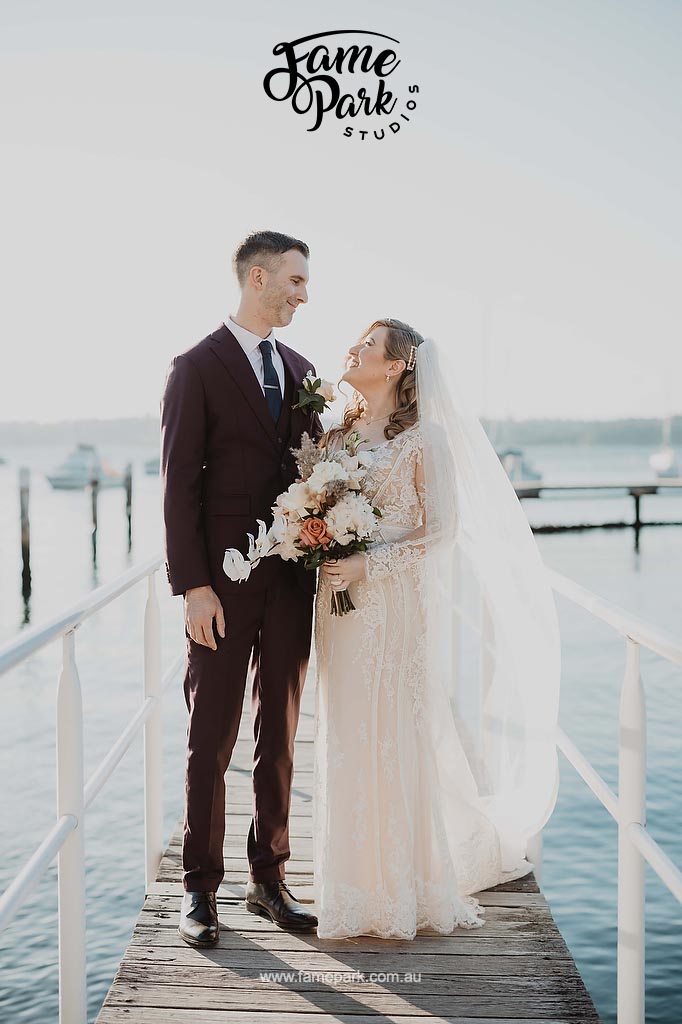 A couple celebrating their wedding ceremony on a beautiful dock venue.