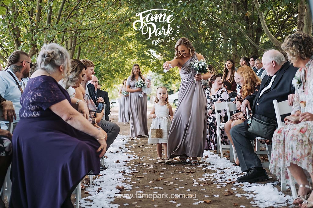 A unique wedding ceremony featuring a little girl walking down the aisle.